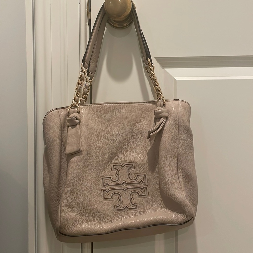 Tory Burch taupe/light pink tote with light denim stains on front.